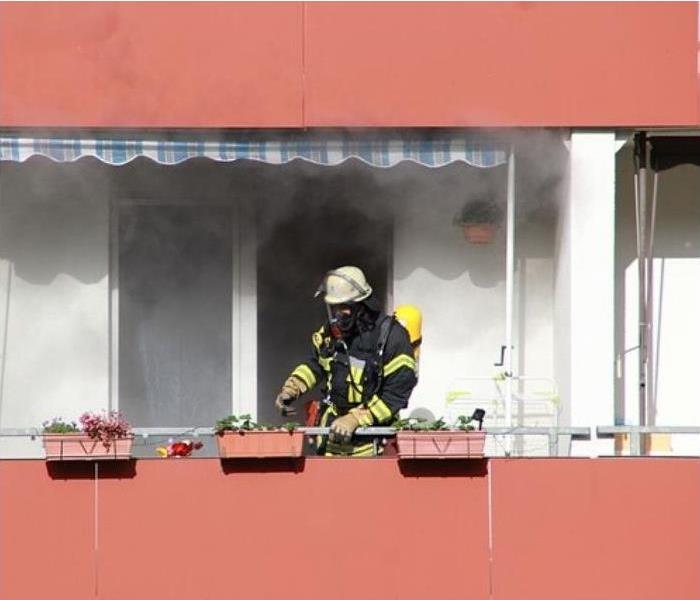 firefighter battling house fire